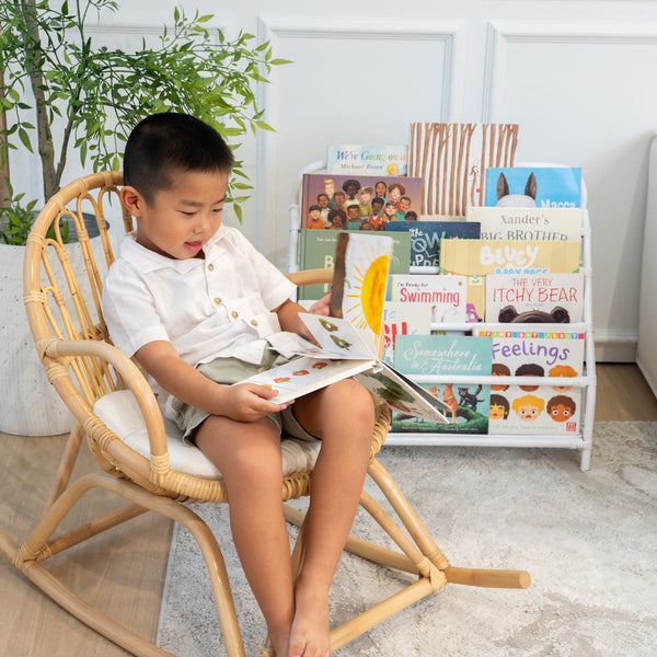 Child reading next to the Elena Kids White Montessori Bookshelf during reading time