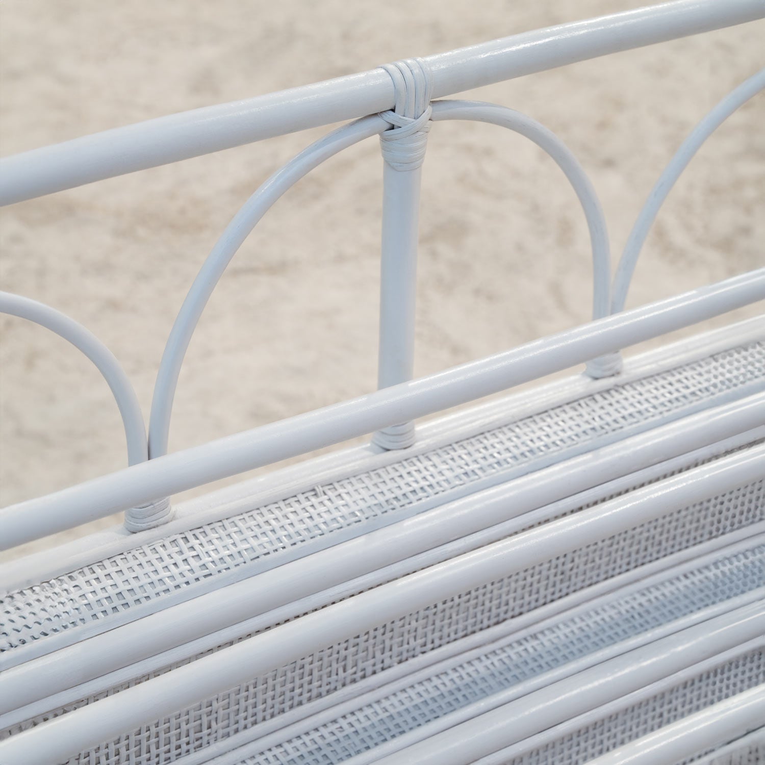 Close-up of the Elena Kids White Montessori Bookshelf showing rattan detail and white finish