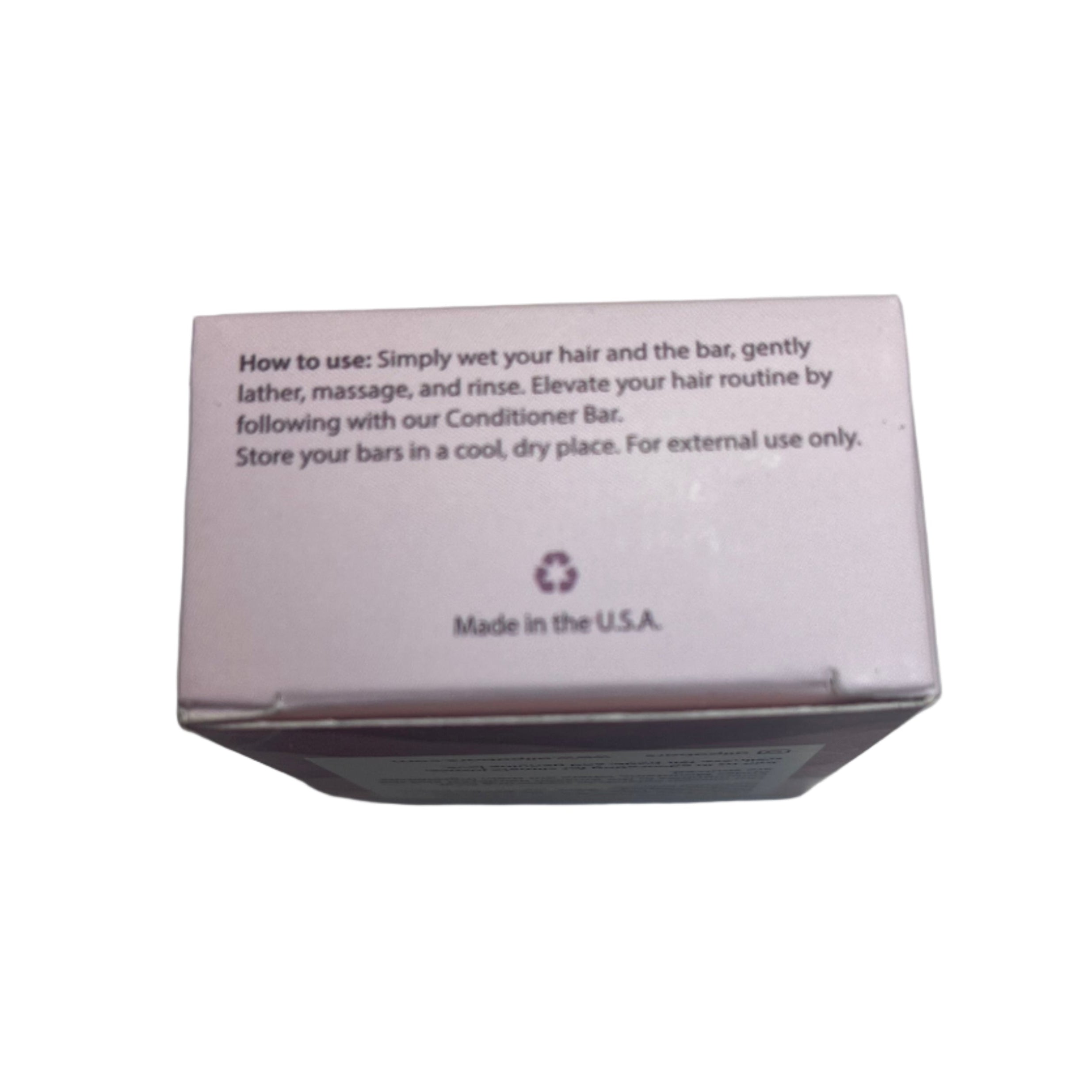 Small pink box with text on a light gray surface: How to use shampoo bar. 