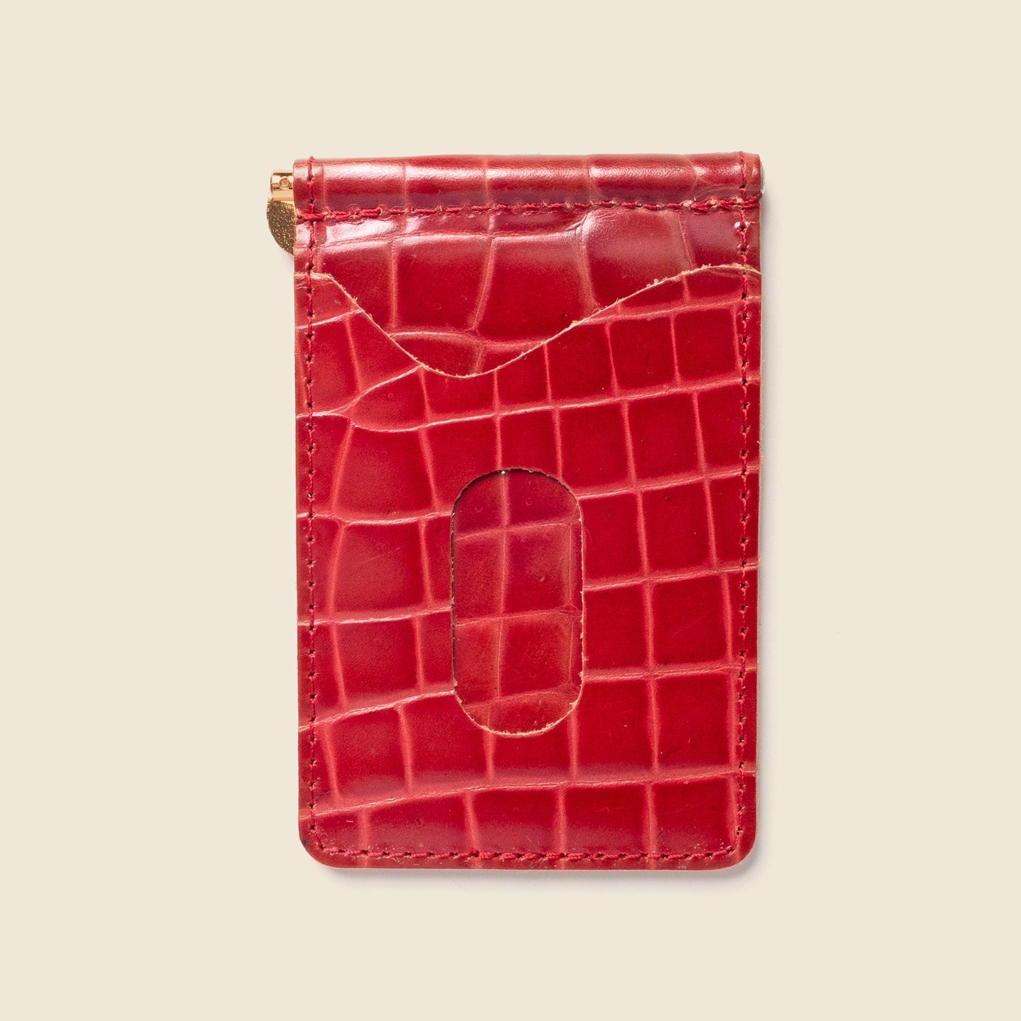 Red crocodile-patterned cardholder on a beige background