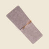 Gray phone case with a gold clip on a beige background