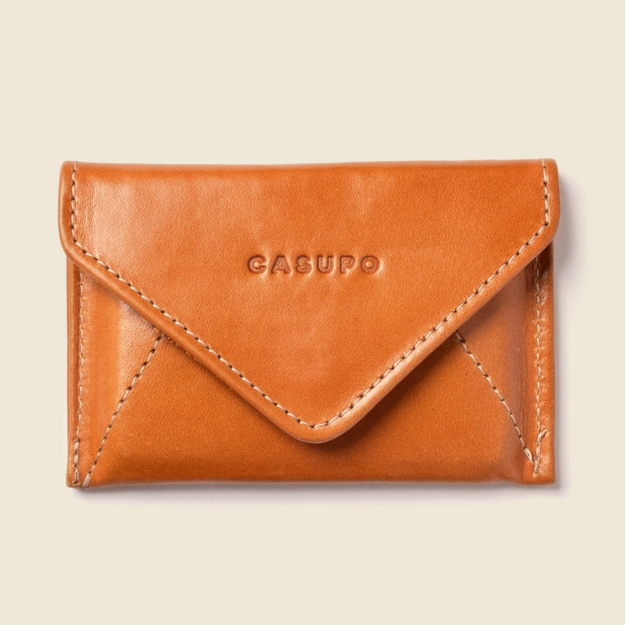 Brown leather wallet with 'CASUPO' branding on a beige background