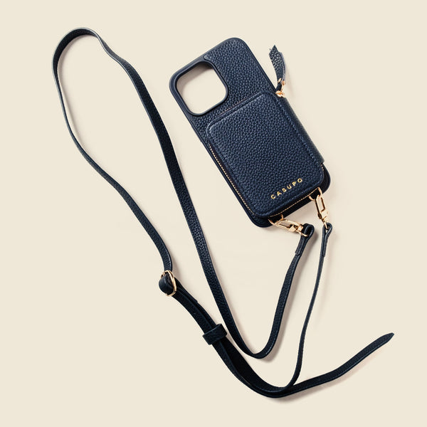 Navy blue phone case with a strap on a beige background