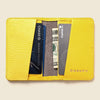 Yellow cardholder with cards and money on a beige background