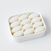 White container filled with oval-shaped objects on a white background
