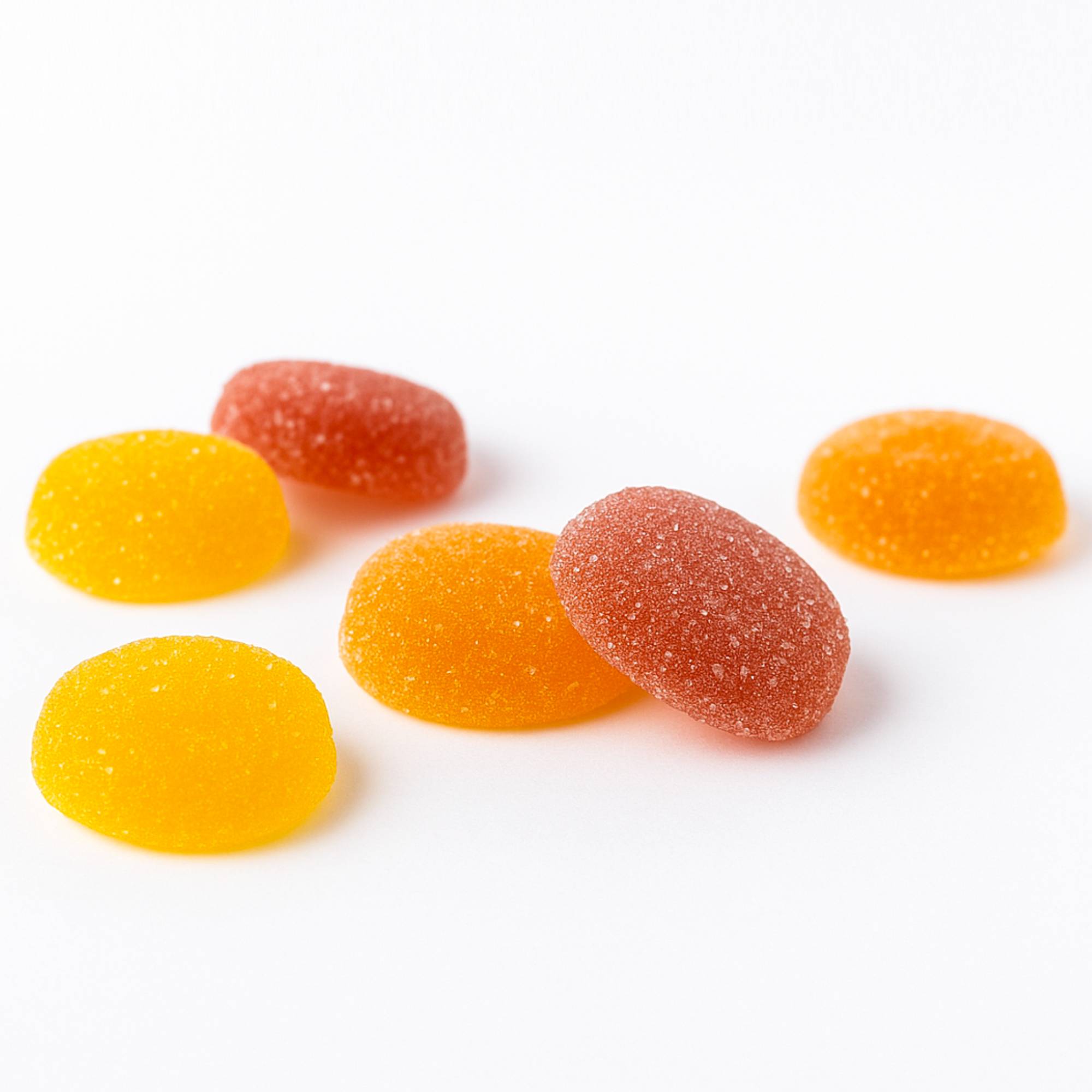 Gummy candies in orange and red on a white background