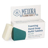 Meliora tea tree scented foaming hand soap refill tablet next to its recyclable paperboard box