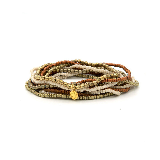 Fair Anita Burst Bracelet Set in gold and peach tones stacked on a wrist