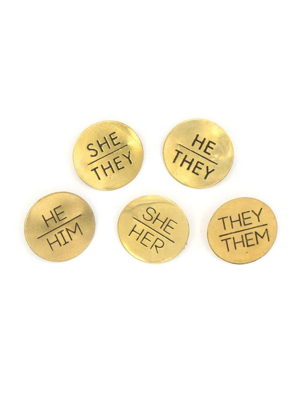Fair trade brass pronoun pins displayed together – sustainable accessories by Fair Anita