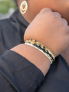 Close-up of Fair Anita elastic bracelet set showing earthy bead details and Burst charm