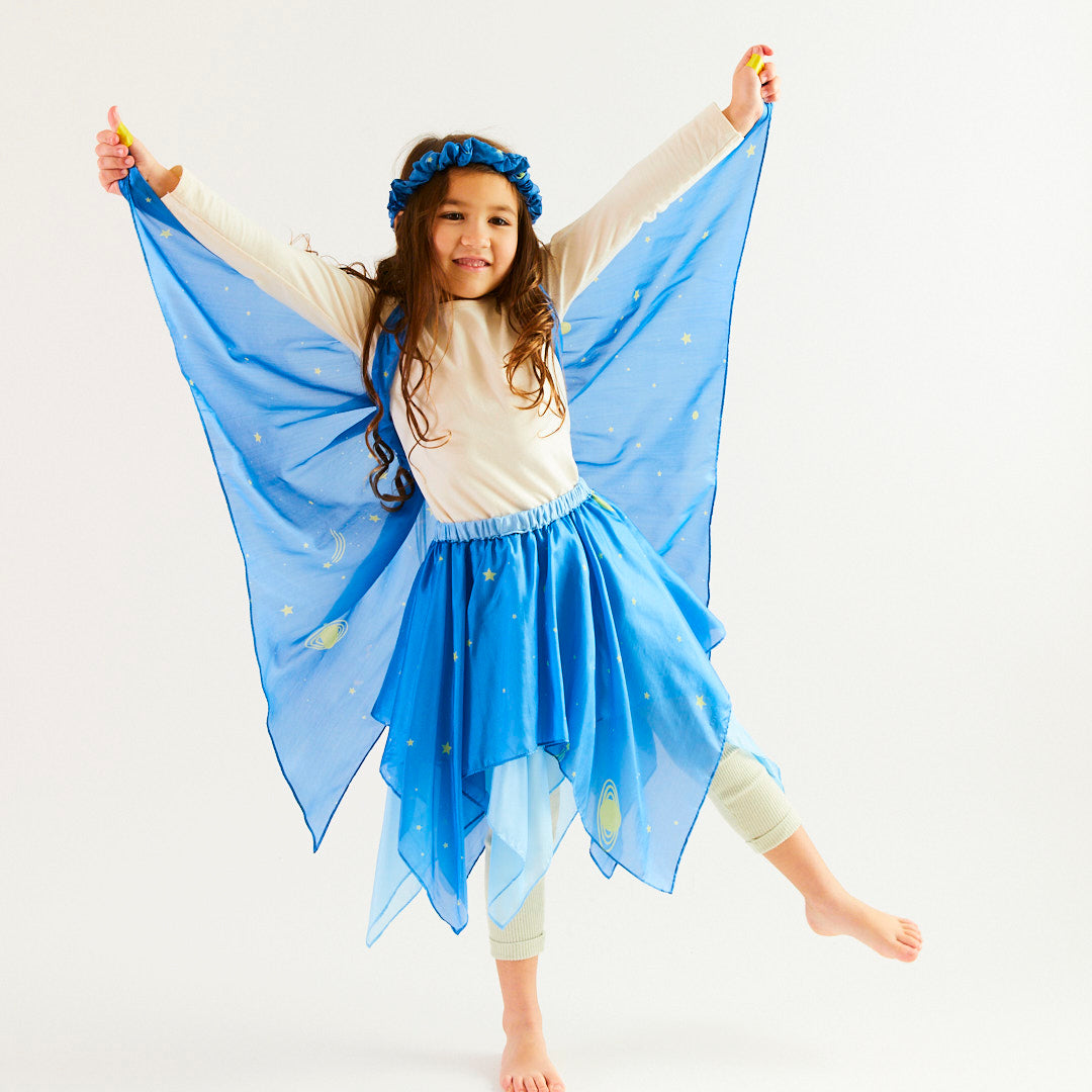 Child wearing a blue fairy costume with wings on a white background