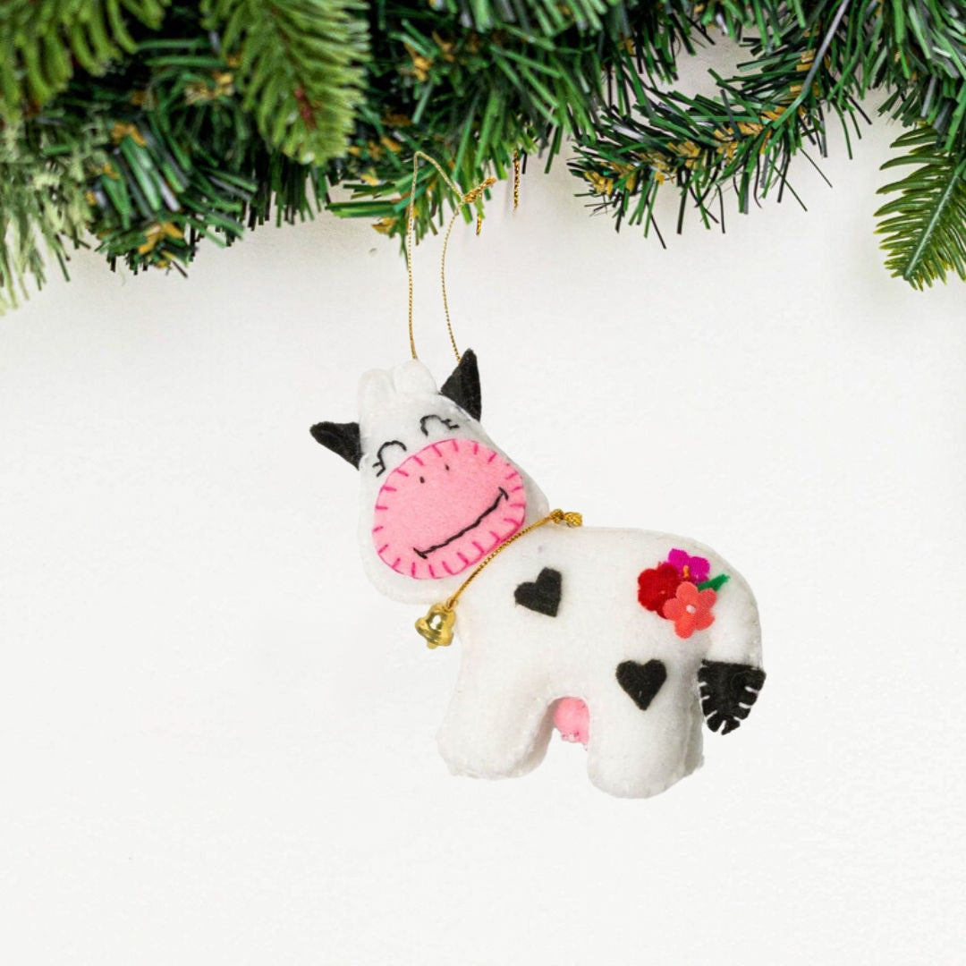 Add a touch of whimsy to your home with our adorable Felt Cow Ornament. Made from sustainable materials and featuring vibrant colors, this ornament is perfect for children and adults alike. Order yours today!