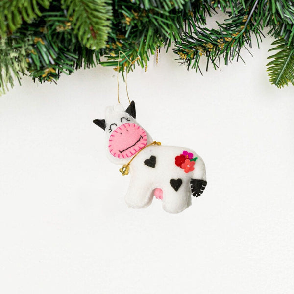 Add a touch of whimsy to your home with our adorable Felt Cow Ornament. Made from sustainable materials and featuring vibrant colors, this ornament is perfect for children and adults alike. Order yours today!