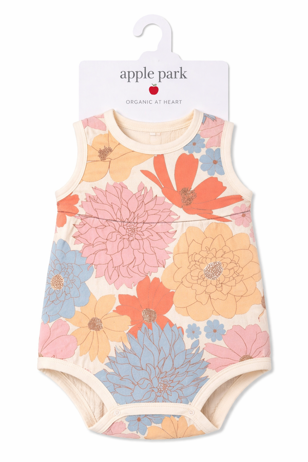 Apple Park Wildflower Picnic Doll Coverall in 100% organic cotton muslin with hand-drawn floral print, laid flat