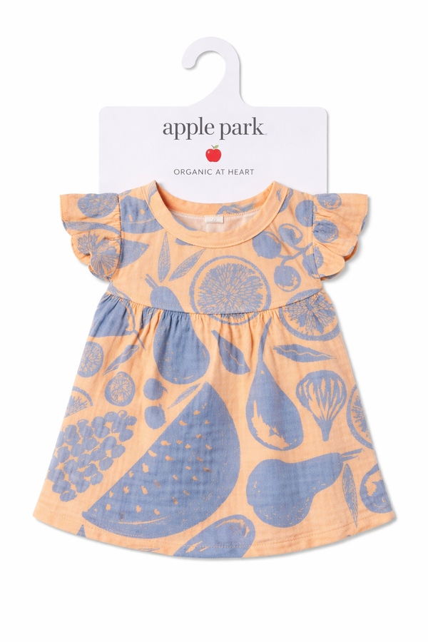 Summer Bounty organic cotton muslin doll dress by Apple Park laid flat, showing hand-drawn fruit print in peach and soft blue tones