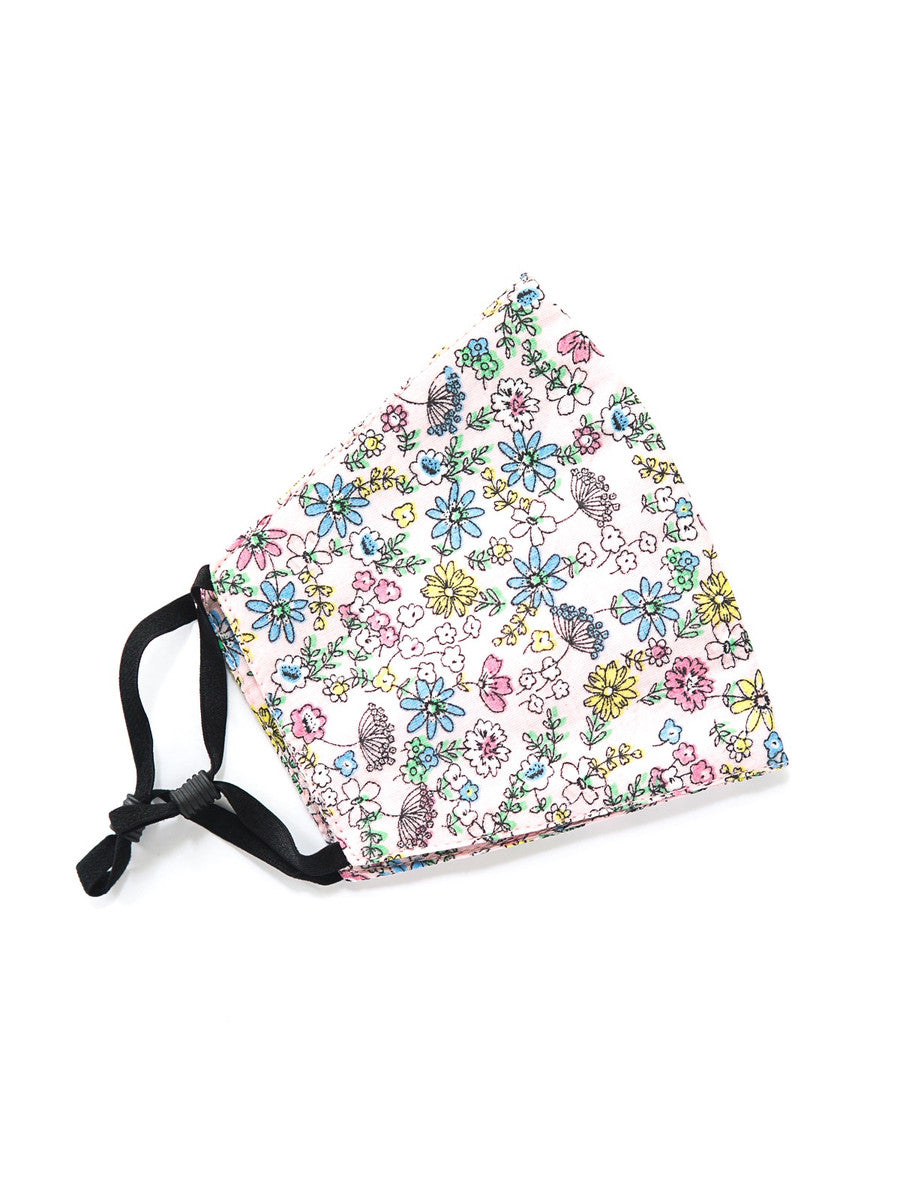 Flat lay of five fair trade cotton face masks in a mix of prints and two sizes