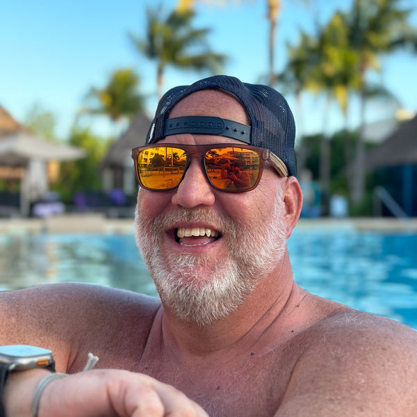 Joycoast Flash Zebrawood sunglasses with polarized orange lenses, angled view
