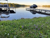 Pond with dock and boats, grassy area in foreground