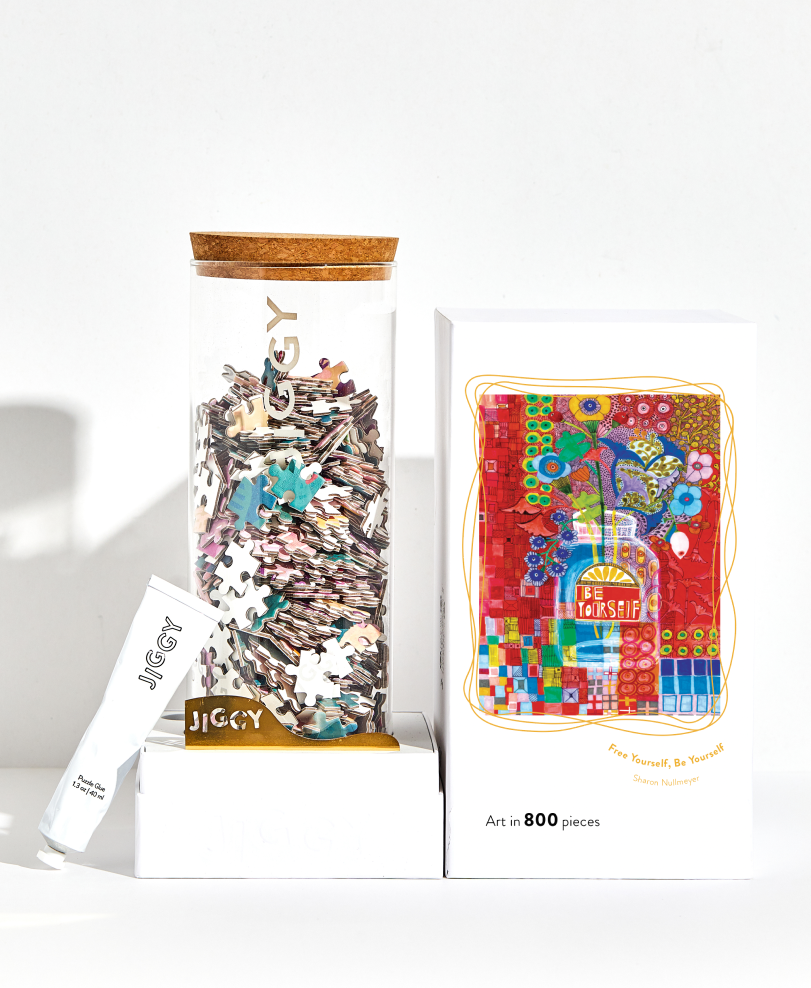 Jigsaw puzzle set with colorful packaging on a white background