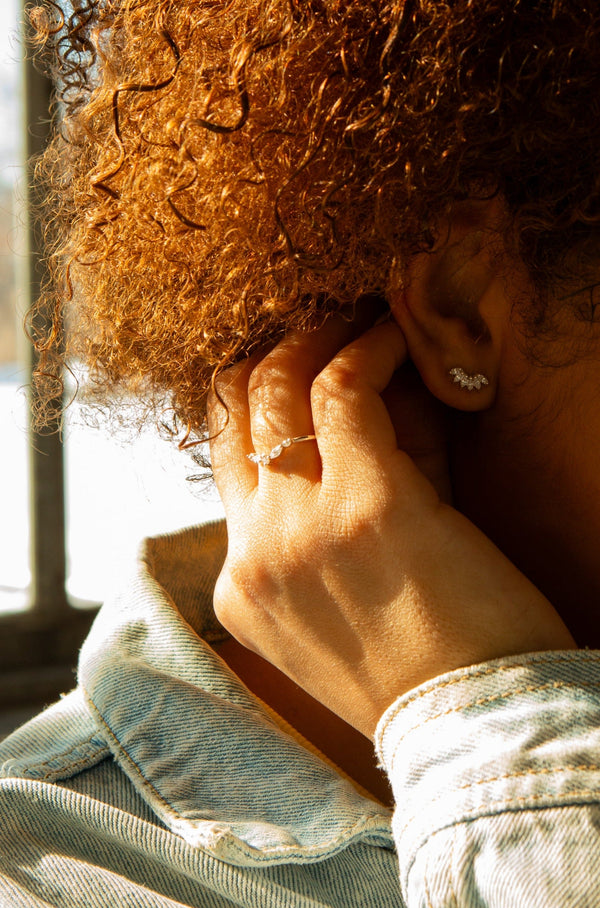 Close-up of Frosting Crystal Sterling Silver Ring paired with Crystal Curve Sterling Silver Stud Earrings