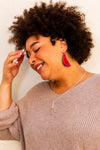 Model wearing beaded fruit slice watermelon earrings handcrafted by artisans in India