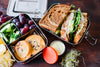 Ecozoi 2-tier bento lunch box packed with meal prep food, showing leak-proof lids and full 60 oz capacity