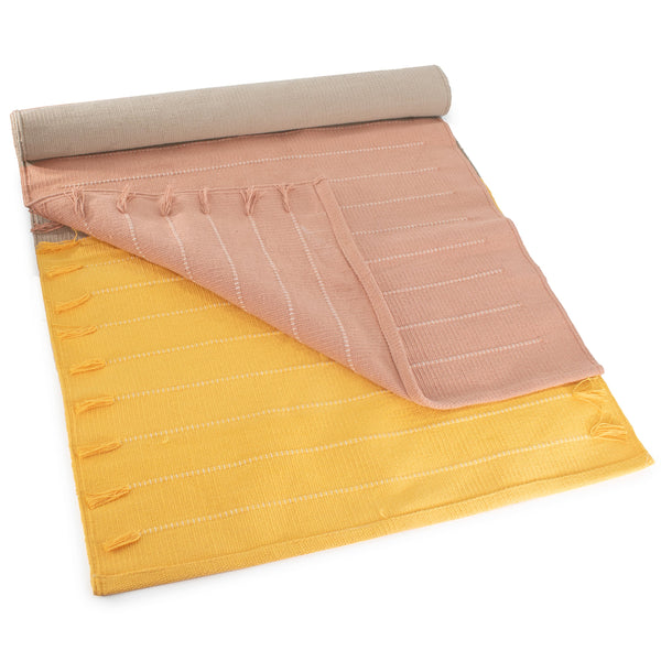 Roll-up mat with pink top section and yellow bottom section on a white background