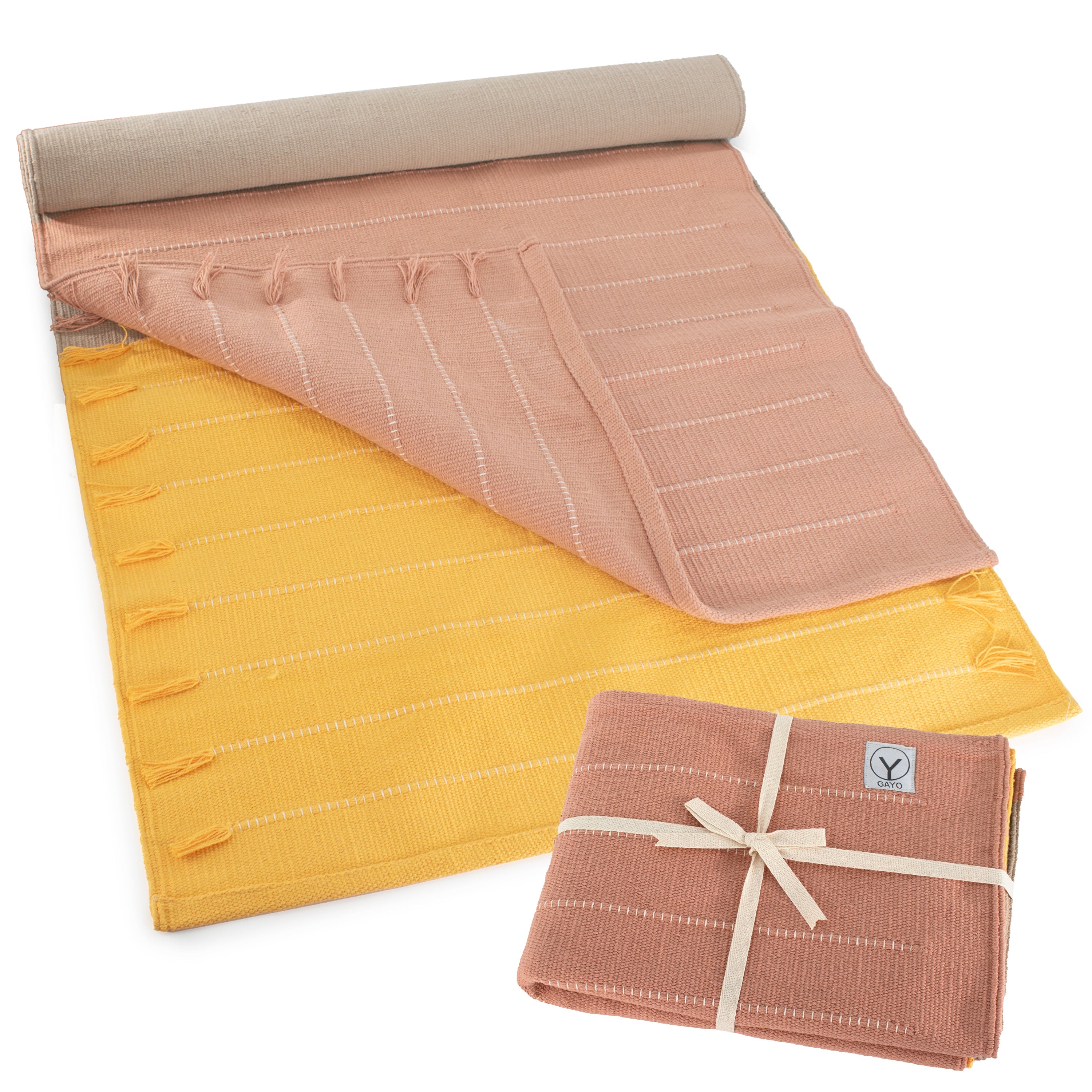 Roll-up mat with pink and yellow pattern on a white background