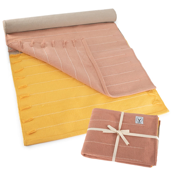 Roll-up mat with pink and yellow pattern on a white background