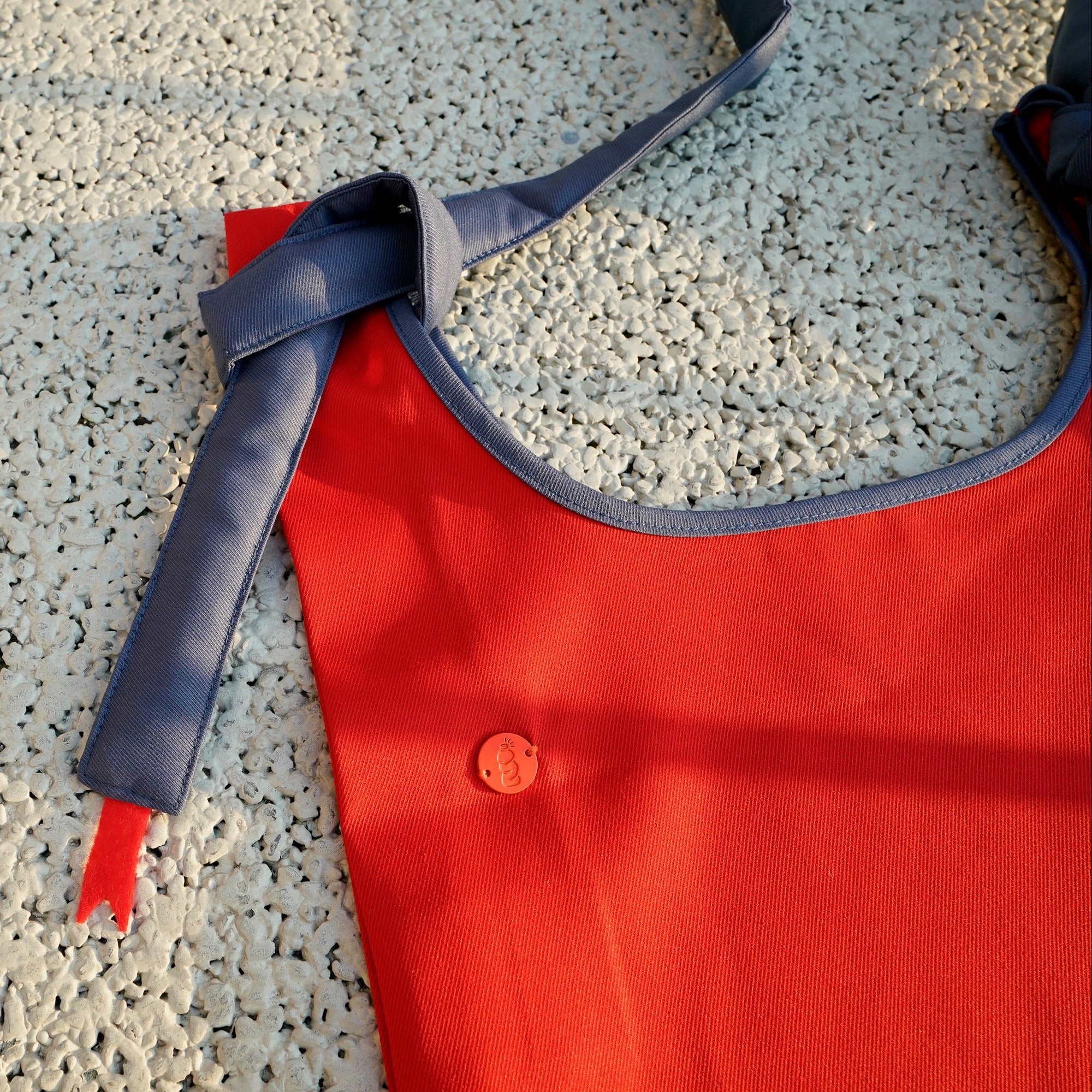 HowBottle Little Snake limited edition red recycled bag with adjustable strap on a textured surface