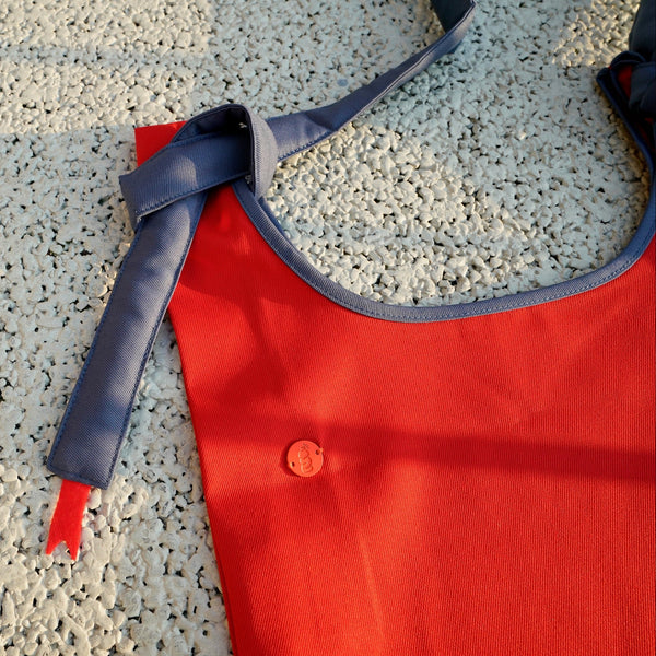 HowBottle Little Snake limited edition red recycled bag with adjustable strap on a textured surface