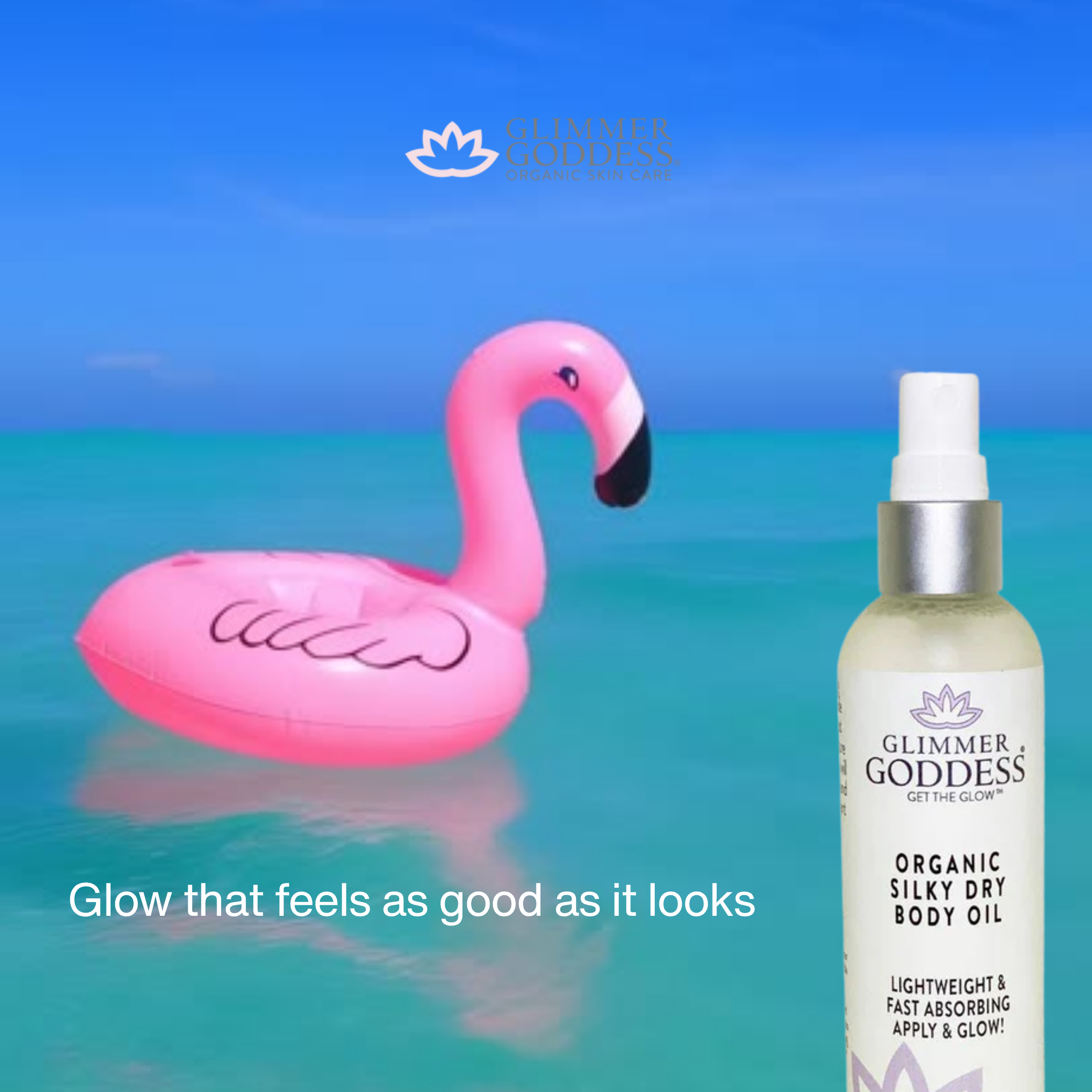 Glimmer Goddess organic silky dry body oil bottle with pink flamingo floatie against a blue ocean background