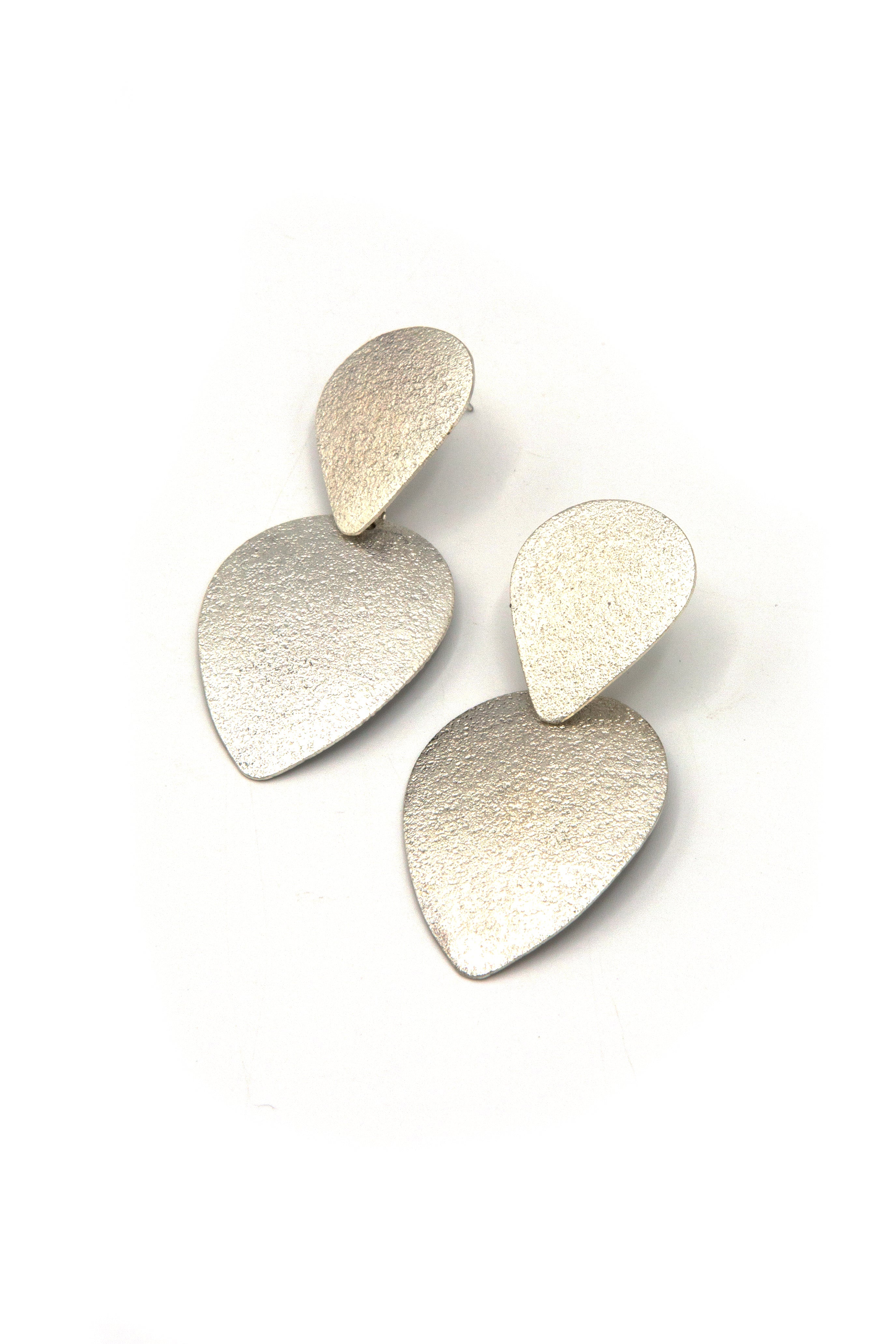 Fair trade silver teardrop earrings handmade by women artisans in India, front view on model