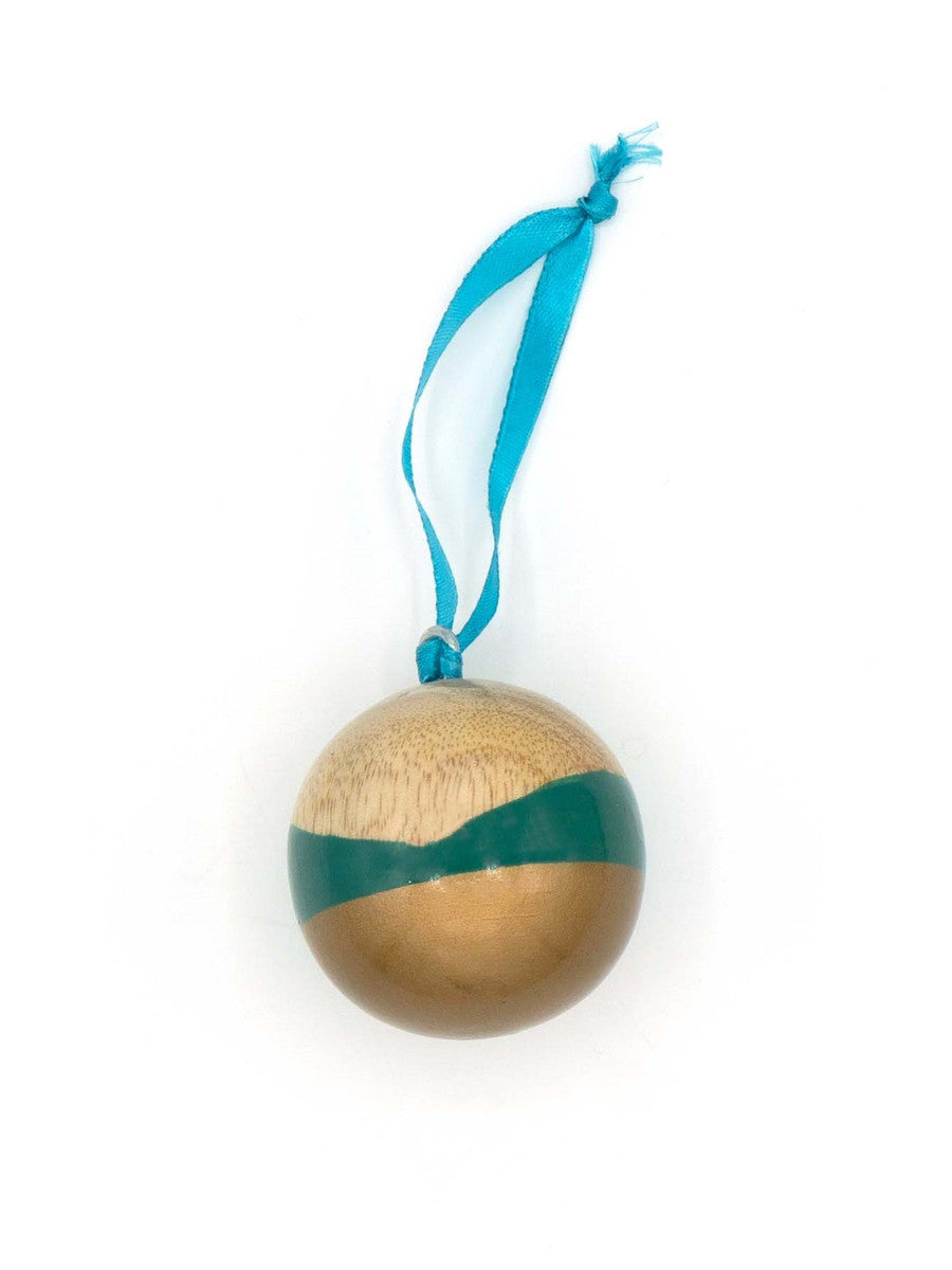 Close-up of painted mango wood round ornament in gold and turquoise tones, measuring 2 inches across