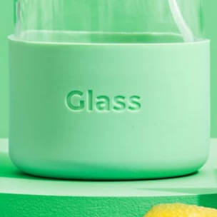Green glass container with 'Glass' text on a green background