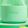 Green glass container with 'Glass' text on a green background