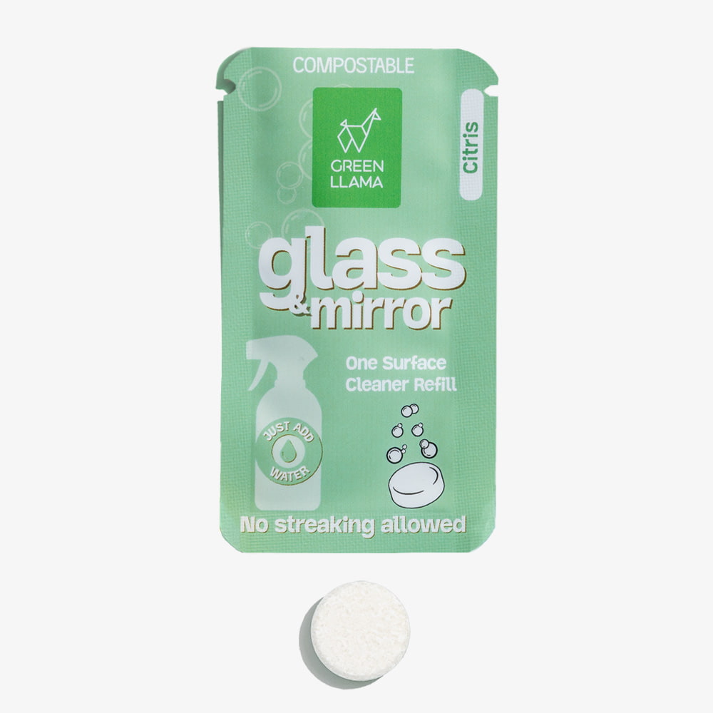 Green package of glass and mirror cleaner refill with a white tablet on a white background
