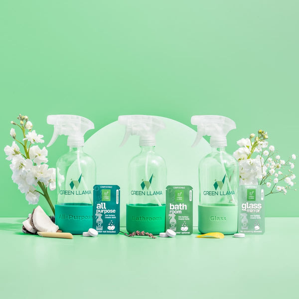 Set of Green Llama cleaning products on a green background. Green Llama Starter Home Cleaner Kit – 3-in-1 eco cleaning bundle with glass bottles & compostable refills. Plastic-free, non-toxic & naturally fragranced.