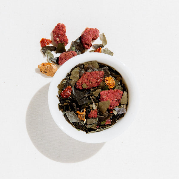 Art of Tea Happy Tea loose leaf blend with raspberries, hibiscus, and botanicals in a white bowl