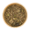 Wooden bowl filled with dried herbs on a white background