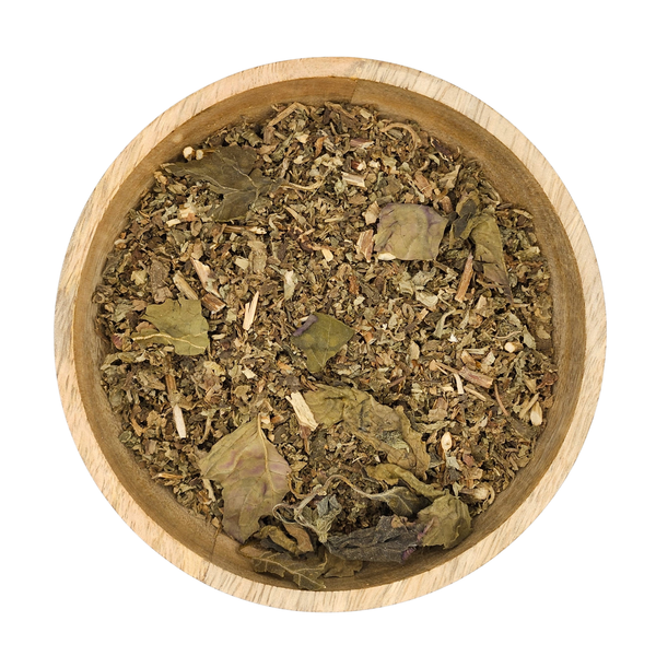 Wooden bowl filled with dried herbs on a white background