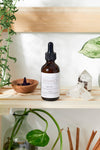 Close-up of Butter Me Up Organics hair oil label showing organic argan and jojoba oil ingredients
