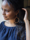 Hammered copper hoop earrings styled on model, nickel-free and 3 inches long, Fair Anita