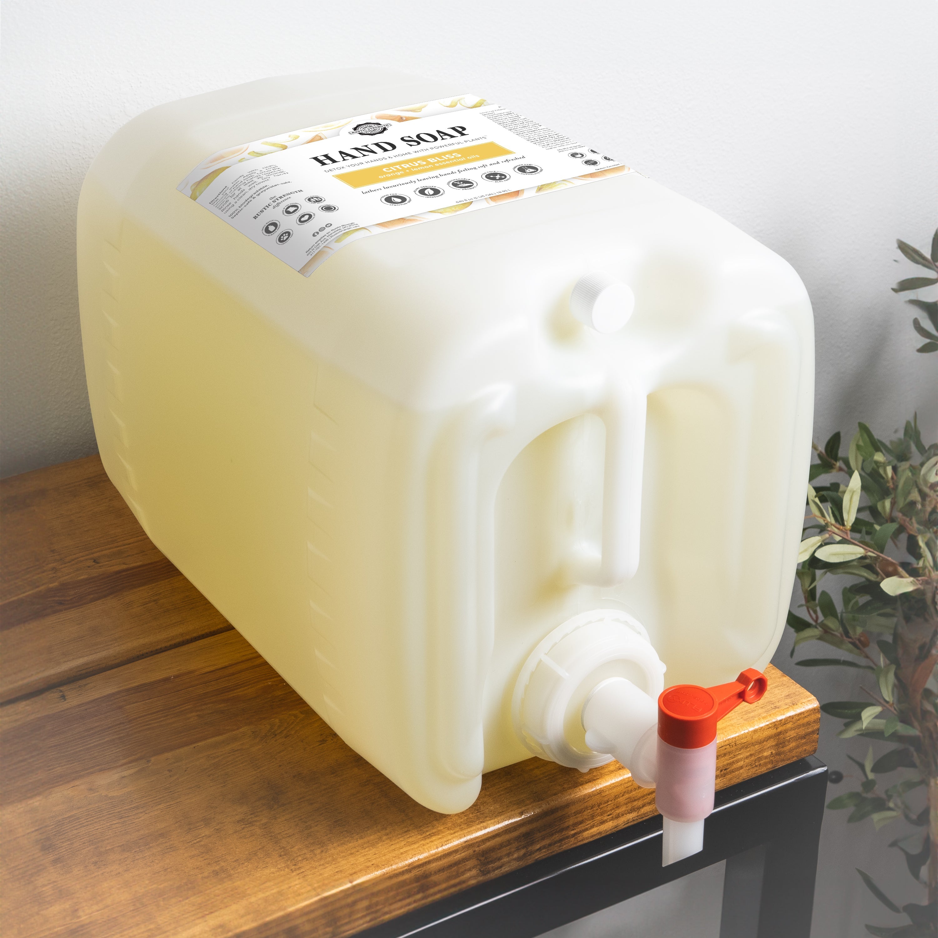 Large plastic container with a pump on a wooden surface