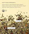 Art of Tea Happy Tea loose leaf ingredients including organic guayusa, raspberries, and hibiscus on a beige background
