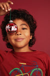 Close-up lifestyle shot of Mon Coeur kids recycled cotton bicycle print t-shirt in Cardinal Red