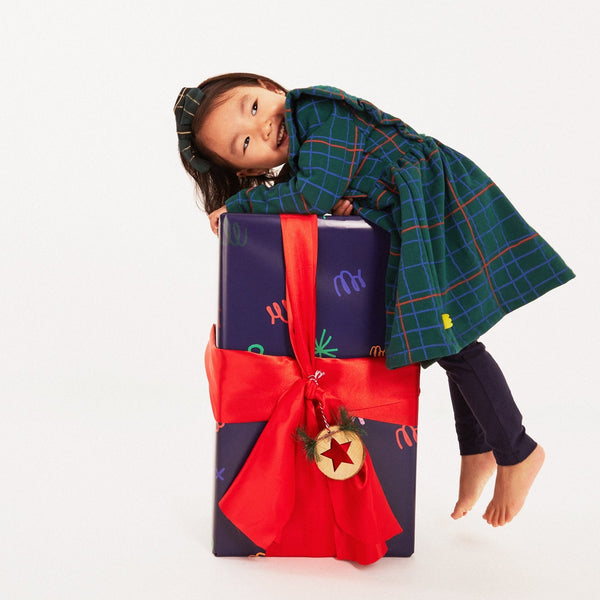 Baby wearing Mon Coeur recycled cotton leggings with a coordinating top, holiday styling