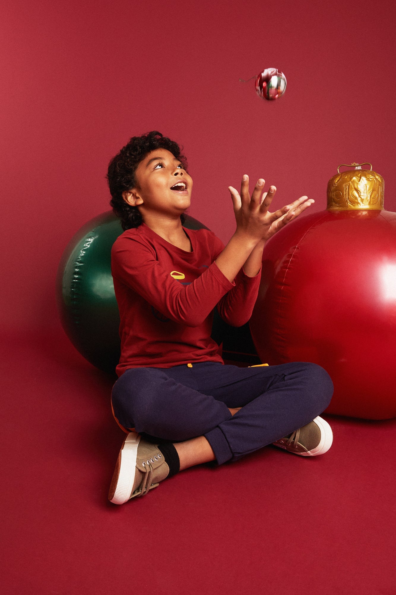 Child wearing Mon Coeur Bicyclette Cardinal Red long-sleeve t-shirt, styled for the holidays