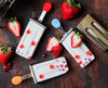 Popsicles with strawberries and red berries on a wooden surface