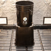 Black plastic bin with a label on a metal surface